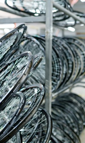 New aluminum bicycle wheels on professional assembly line, spokes installation, nobody. Bike parts on factory, cycle rims with hubs on machine, modern technology